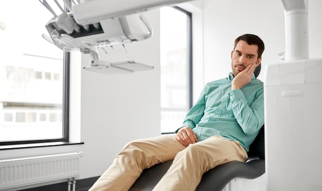 patient suffering from toothache at dental clinic