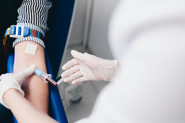 The patient takes a blood test at the clinic