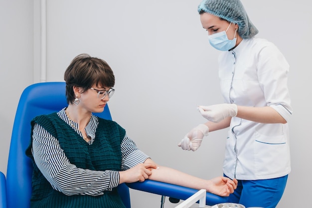 The patient takes a blood test at the clinic