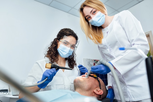 The patient treats and whitens teeth at the dentist in the clinic