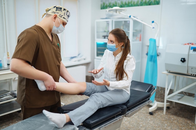 Patient visit doctor after suffering leg injury Doctor examines patient examines picture of patient