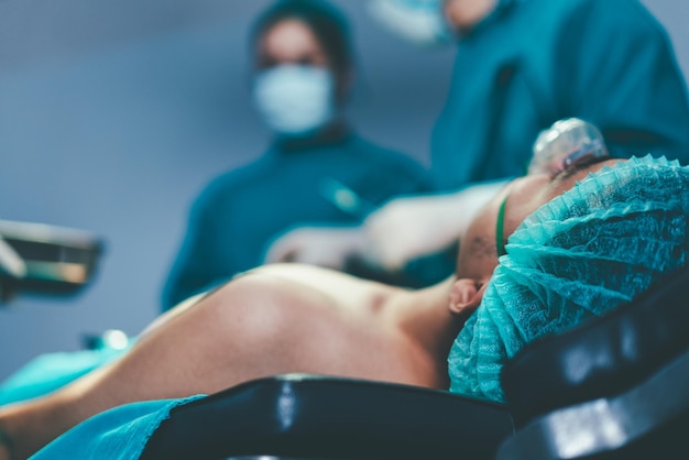 Patient wearing ventilator lying on bed the operating bed\
during surgery process