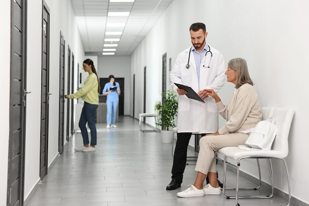 patients waiting for appointment and doctors in hospital hallway selective focus