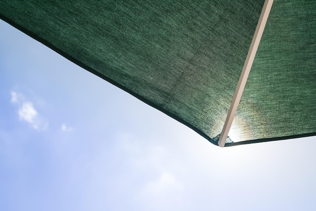 Patio umbrella against blue sky with clouds in the summerprotection from the sun concept copy spaces