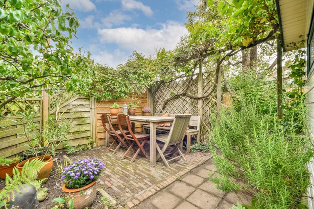 A patio with a table and chairs in a garden