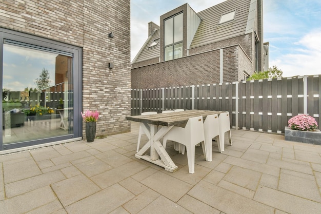 A patio with a table and chairs on it