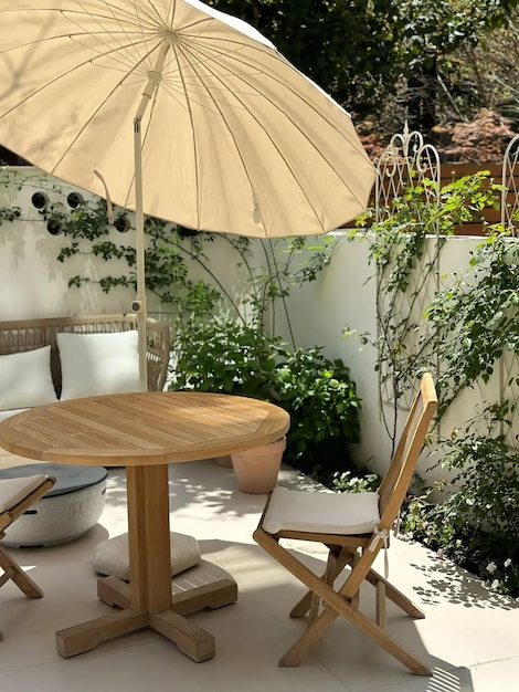 A patio with a table and umbrella and chairs