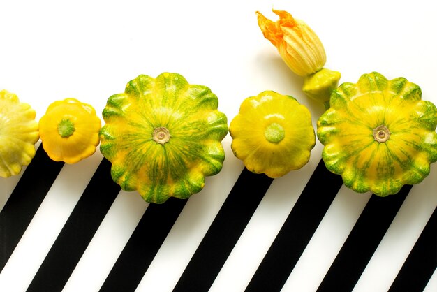 Patisson, Squash, dish-shaped pumpkin, raw vegetable on a dark wooden background.