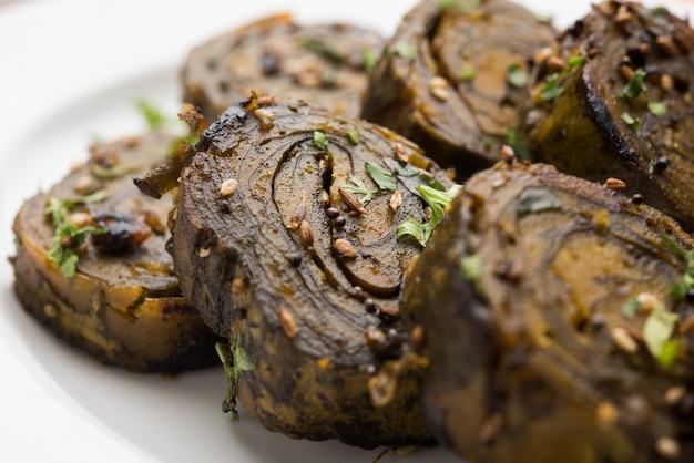 Photo patra or paatra or alu vadi is a popular maharashtrian and gujrati snack recipe made using colocasia leaves, rice flour and flavourings spices, tamarind, and jaggery, selective focus