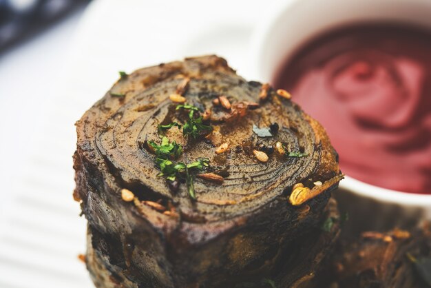 Photo patra or paatra or alu vadi is a popular maharashtrian and gujrati snack recipe made using colocasia leaves, rice flour and flavourings spices, tamarind, and jaggery, selective focus