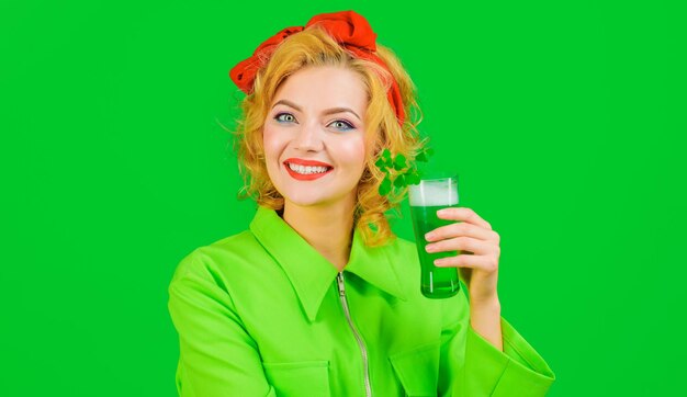 Patricks day smiling woman with glass of beer green beverage with clover irish traditions