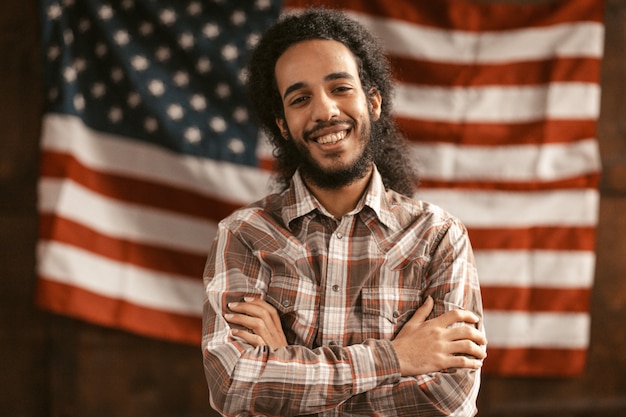Patriotic American Man Cheerfully Laughs With His Arms Crossed