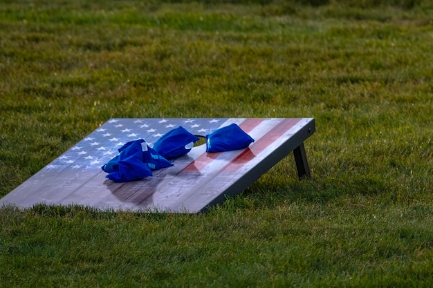 Photo patriotic bean bag toss game on grassy field in park