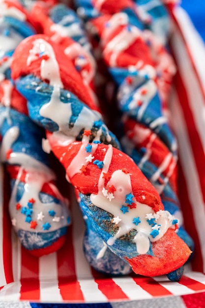 Photo patriotic cinnamon twists drizzled with a white glaze and decorated with star sprinkles