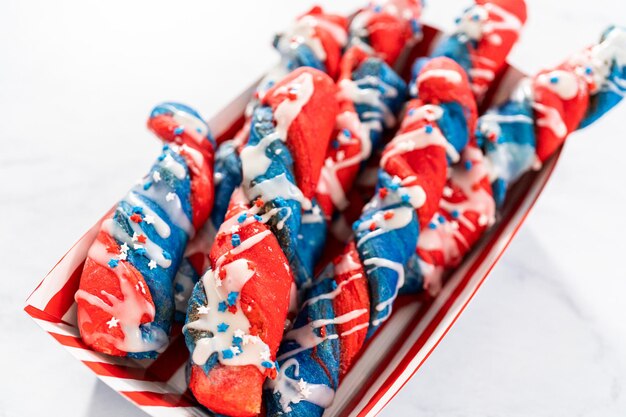 Patriotic cinnamon twists drizzled with a white glaze and decorated with star sprinkles.