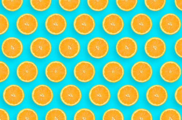 Patroon van een oranje citrus plakjes op heldere blauwe achtergrond