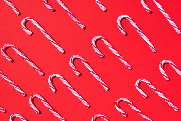 Pattern of christmas candy cane on red background top view flat lay creative minimal concept greeting card on christmas and new year art composition