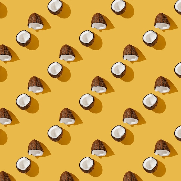 A pattern of coconuts on a bright yellow background