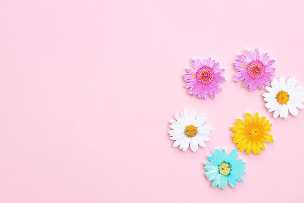 Pattern of colored flowers on pink background