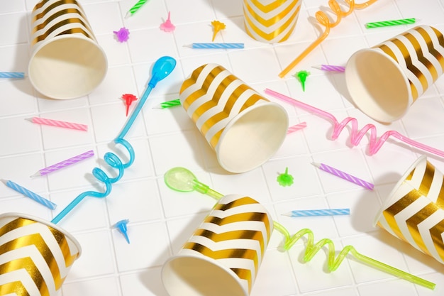 A pattern of colorful paper cups and straws for various drinks Colorful celebration design