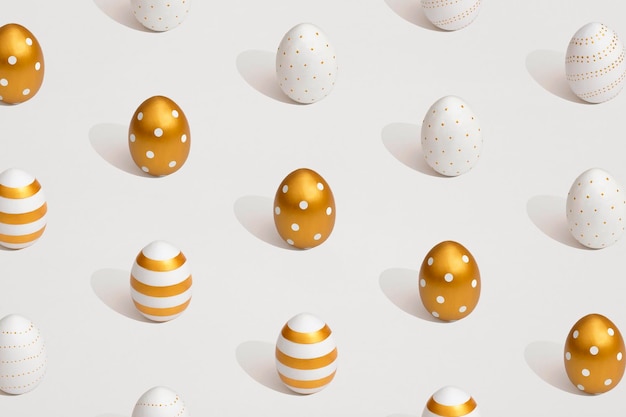 Pattern composition of golden eggs on a white background Minimal easter concept