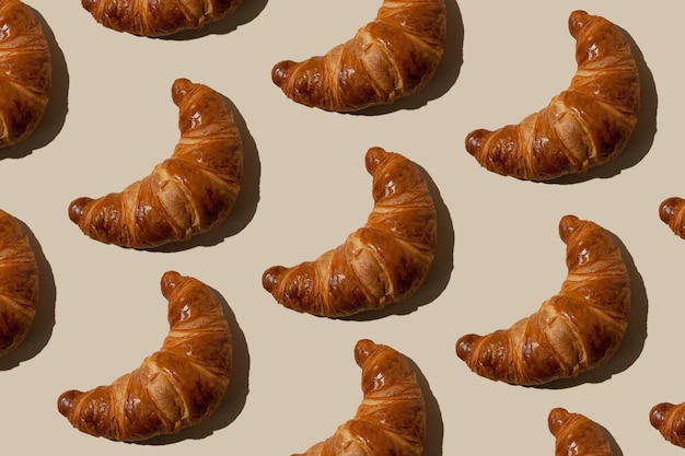 Pattern of croissants on a light background Baking concept