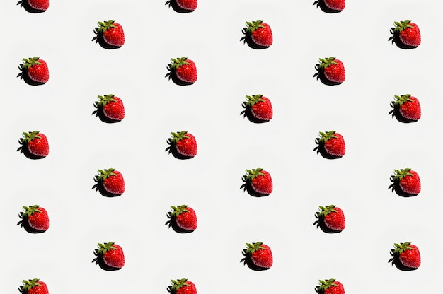 Photo pattern of delicious strawberries on white surface