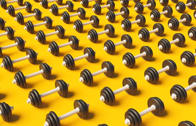 Pattern of dumbbells on yellow surface with soft shadow 