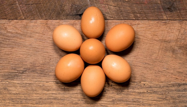 Pattern of eggs on rustic wooden table for Easter