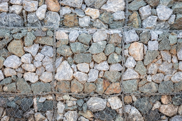 Pattern of grey stone wall with metal grid texture and background