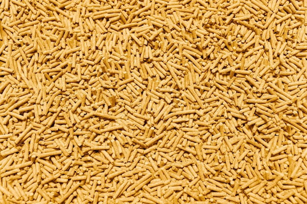 黄色の健康的な有機豆腐猫砂のパターン自然な抽象的な背景