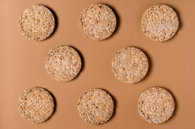 Pattern of healthy whole grain crispbreads on a brown wall photo taken from above