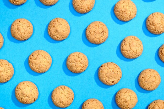 Photo pattern made of sweet cookies on blue background. flat lay