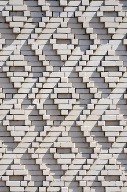 A pattern made of white bricks in the form of diamond shapes.