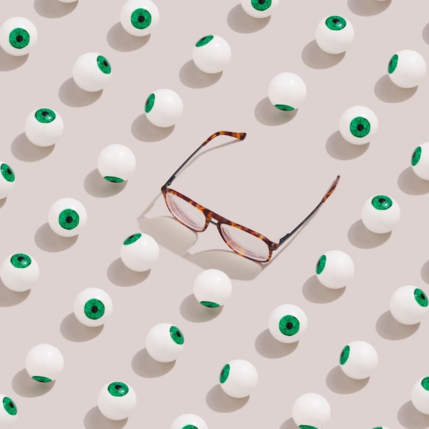 Pattern made with glasses and eyeballs. Сreative idea ophthalmology.