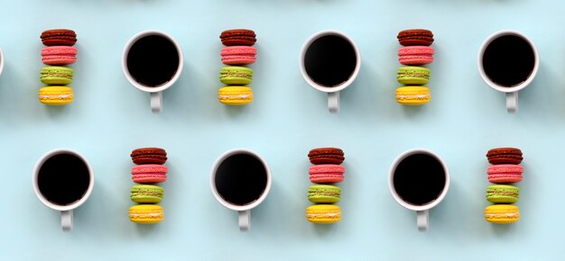 A pattern of many colorful dessert cake macaroon and coffee cups 