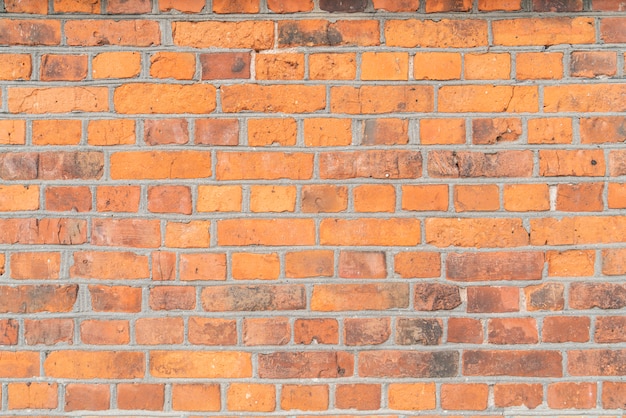 The pattern of the old red brick wall with rough texture and surface