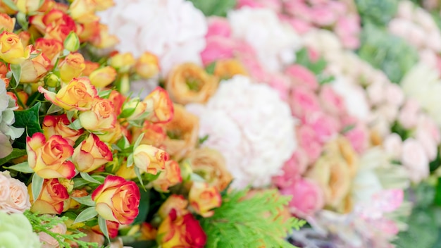 Pattern of pink, yellow, orange and red roses.