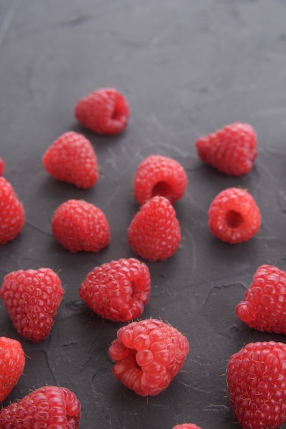 Pattern of raspberry on dark rock background