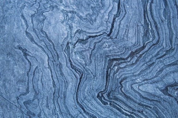 Photo the pattern and surface of the blue white and black marble walls for the background.