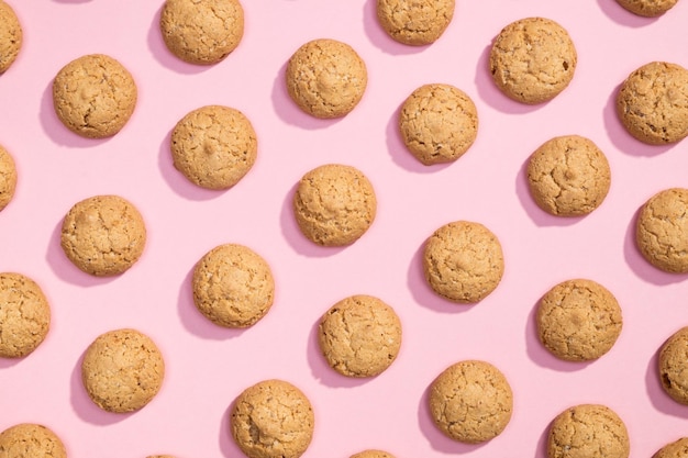 Pattern of sweet cookies on pink background