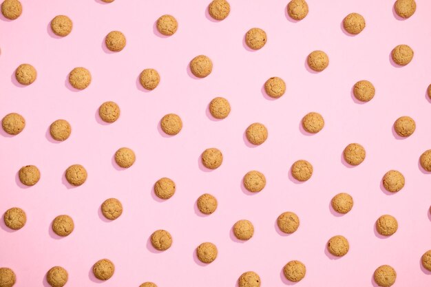 Pattern of sweet cookies on pink background