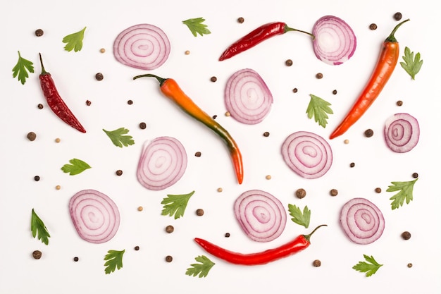 Pattern of vegetables. Food background. Composition of red onion, chili peppers, parsley