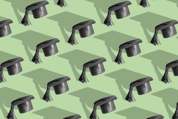 Pattern with black graduated cap on green background with hard shadow Education background