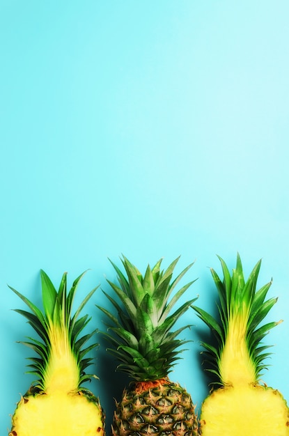 Pattern with bright pineapples on blue 