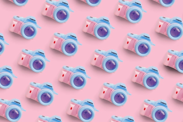 Pattern with camera on pastel color background top view