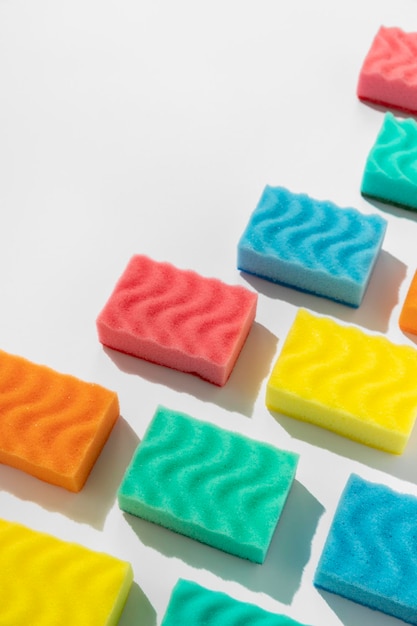 Photo pattern with colorful sponges for dishwashing on white background