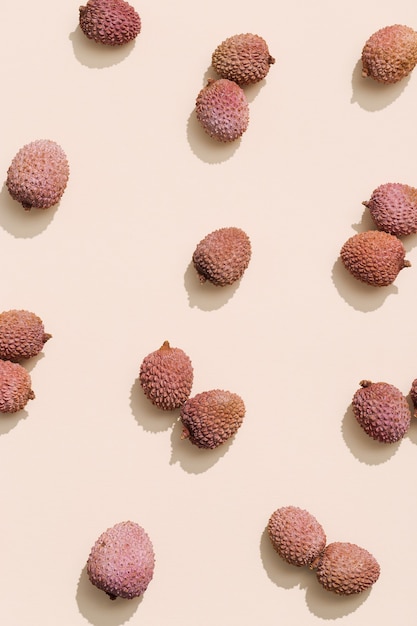 Pattern with fresh Lychee fruit on pastel beige background Minimal fruit and summer concept