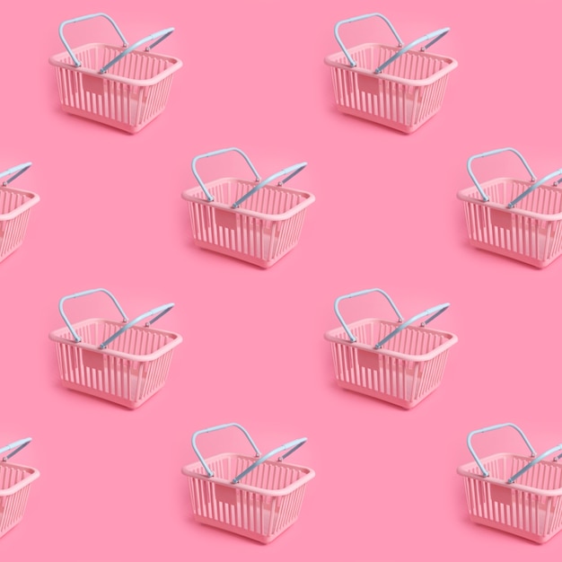 Pattern with pink plastic shopping basket on pink pastel background creative minimalist design