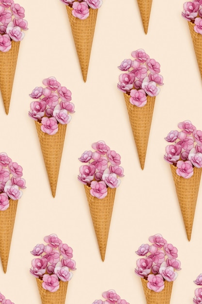 Pattern with waffle ice cream cone filling small flowers Summer time food concept